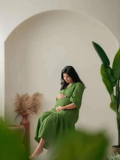 A quiet moment of connection with the baby. This shot, framed by foreground plants, creates a sense of intimacy and privacy.