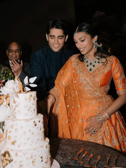 The cake cutting moment. Her makeup is designed to look perfect from every angle, even in candid shots.