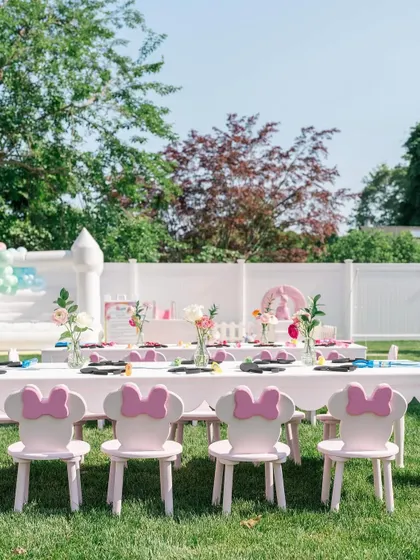 Adorable Minnie Mouse-themed chairs and tables set up for the little guests at the "Anayaland" party. We believe even the kids' seating should be part of the magic.