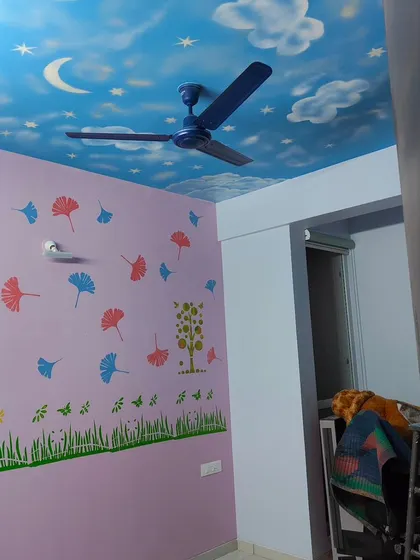 This view shows how the different elements of the kids' room come together, from the sky ceiling to the stenciled walls, creating a cohesive and imaginative space.