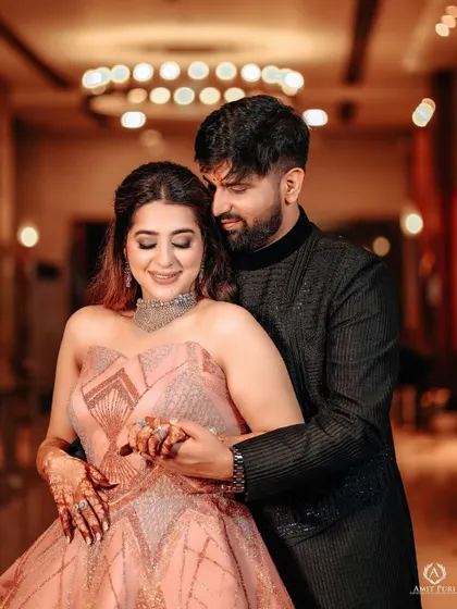 A romantic portrait from a glamorous reception. The couple's coordinated outfits and the soft lighting create an image of pure elegance and love.