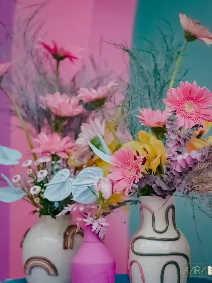 A detail shot of the quirky floral arrangements from the 'Mehendi Fiesta'. I used a mix of colorful gerbera daisies and painted anthuriums in artistic vases to match the playful, retro vibe.