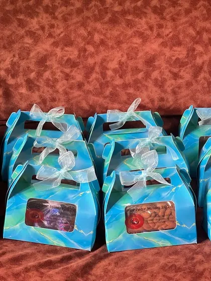 A bulk order of gift boxes for a community event. The vibrant blue boxes with a clear window are perfect for handing out favors and can be customized for weddings or other parties.