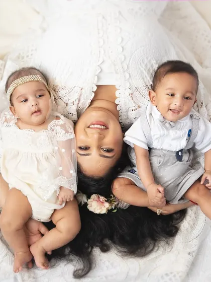 A beautiful overhead portrait of a mother with her boy and girl twins. This pose creates a lovely, symmetrical composition that is full of love.