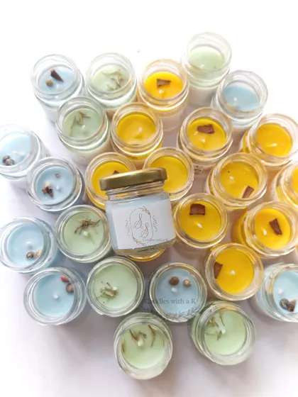 An assortment of mini jar candles in different colors and scents, created as wedding return gifts for a client in Bhubaneswar.
