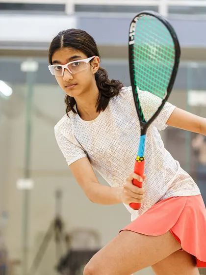 A powerful portrait of 15-year-old Samairah Bhandare, ready to return a volley. Her focused expression and ready stance show a maturity and skill beyond her years.