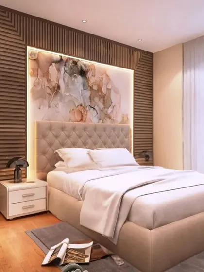 Another shot of the elegant bedroom with the plush upholstered headboard and abstract art. The warm lighting and wooden textures create a perfect retreat for relaxation.