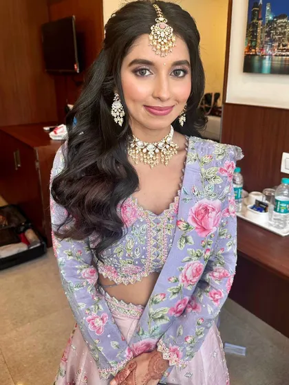 A smiling portrait that shows off her beautiful makeup and intricate jewelry.