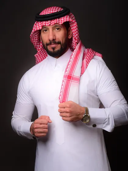 A confident three-quarter portrait of a professional from Saudi Arabia. The focus is on capturing a strong yet approachable expression.