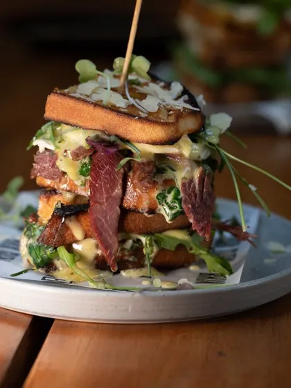 Another angle of our towering ciabatta sandwich, showing the generous fillings and melted cheese.