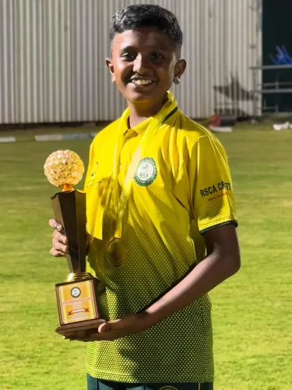A proud player with her trophy after a successful tournament.