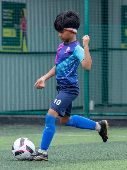 A U11 player demonstrates perfect form while striking the ball. We focus on teaching proper technique from the very beginning.