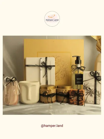 A modern and artistic hamper for dad. This set includes a unique face-shaped mug, a journal, hand soap, and jars of nuts, all tied with simple black string for a minimalist aesthetic.