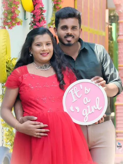 A happy gender reveal for a baby girl. The couple's joy is infectious in this colorful outdoor setting.