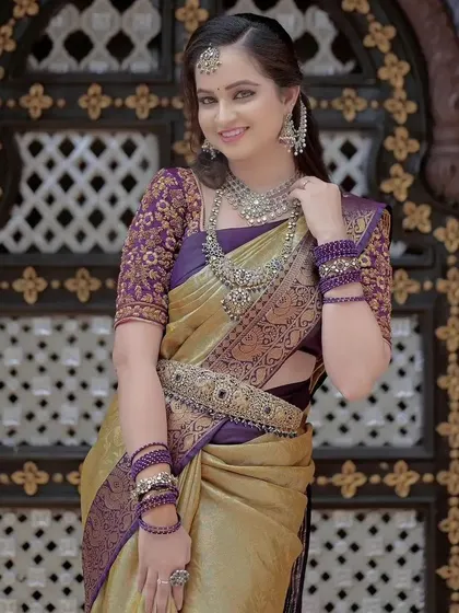 A full view of the purple and gold silk saree, highlighting its rich texture and beautiful drape. This is a perfect choice for a bride or a wedding guest looking for a regal outfit.