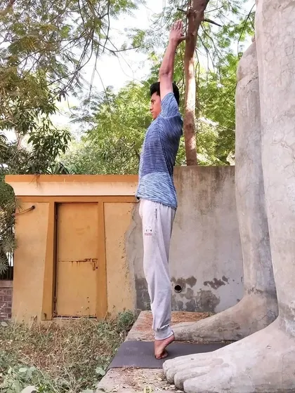 Tadasana, or Mountain Pose, on the toes. This simple yet powerful asana improves posture, strengthens the thighs and ankles, and firms the abdomen, creating a feeling of lightness in the body.