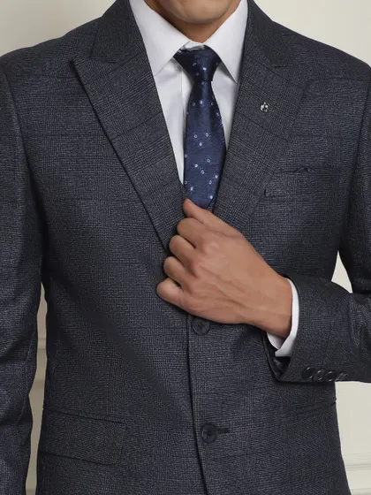 A close-up of the textured fabric and classic notched lapel of our navy blue formal suit.