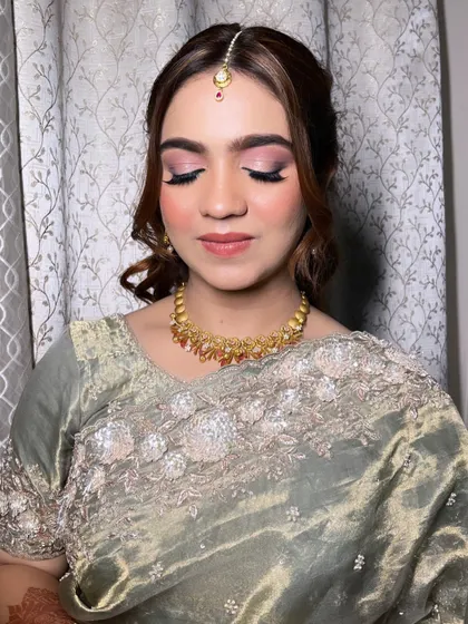 A detailed look at the eye makeup for this elegant party style. The blended pink and brown tones create a sophisticated look that is both modern and timeless.