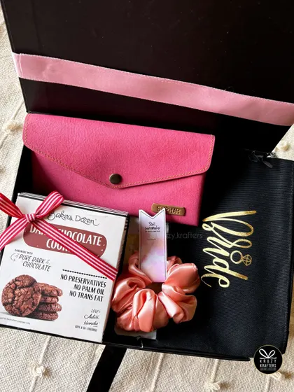 A simple and elegant bride hamper on a budget, containing a personalized 'Bride' pouch, cookies, and a satin scrunchie, all beautifully packed.