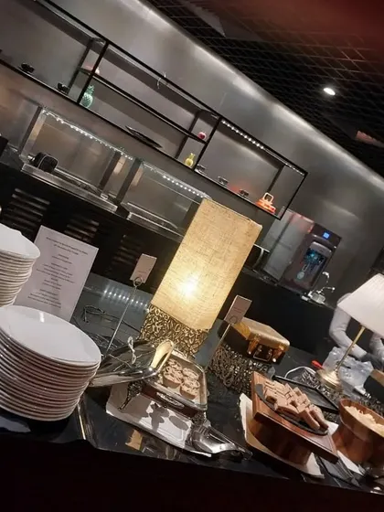 A sleek and modern buffet setup for a Spotify India creators' event. The dark, moody lighting and stylish serveware were chosen to match the creative and contemporary vibe of the brand.