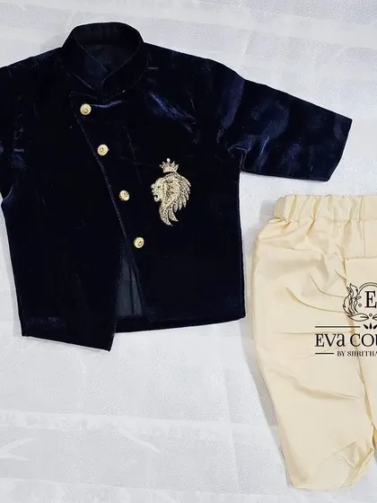 Another view of the newborn-sized navy blue velvet jacket and dhoti set.