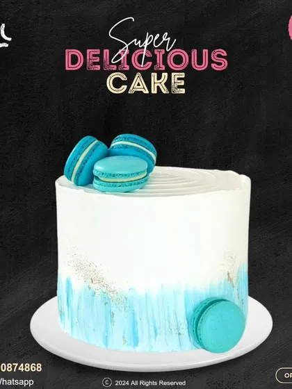 A chic and simple cake topped with vibrant blue macarons. The watercolor-style blue frosting on the bottom half adds a touch of artistic flair to this modern design.