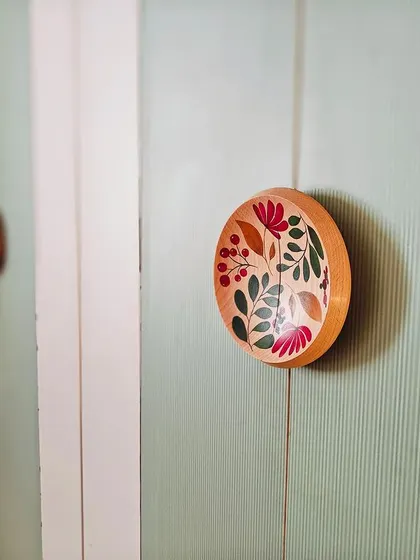 The smallest details tell the biggest stories. These custom wardrobe handles were hand-painted by artisans, turning a functional element into a unique piece of art that adds a personal, floral touch to the bedroom.