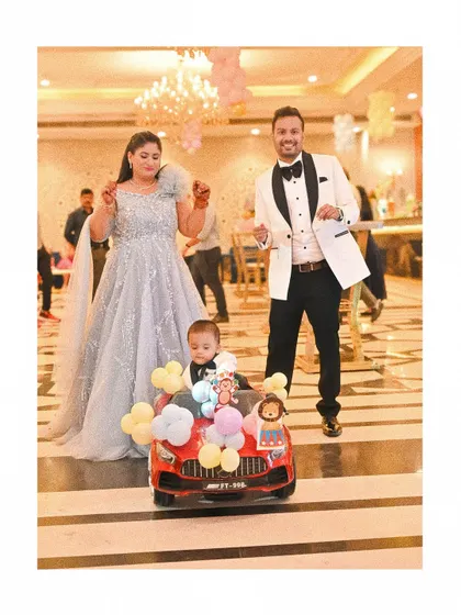 Capturing the grand entrance at a first birthday party. I focus on candid event photography to document the real fun and excitement of your celebration, like this little one arriving in his own balloon filled car.