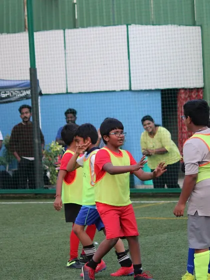 A candid moment of communication and strategy between players on the field during a tournament match.