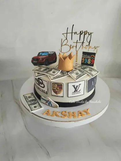 For Akshay, who loves all the good things in life. This cake is decorated with logos of luxury brands like Porsche and Louis Vuitton, a car, and edible money.