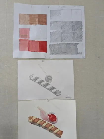 Here you can see student exercises in creating value scales with watercolor and pencil. This is a fundamental step before tackling complex object studies, as it teaches control over tone and shading.