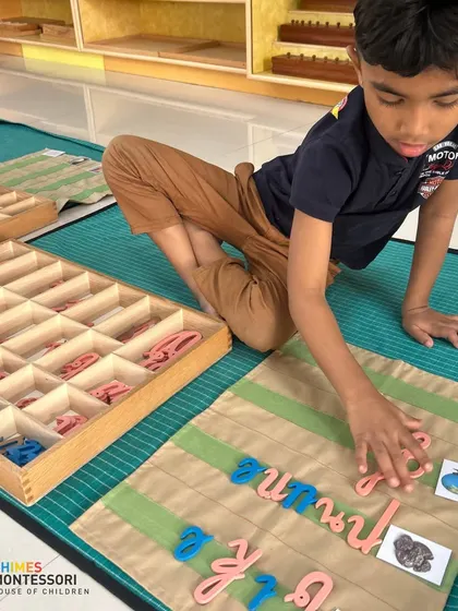 A child works with the movable alphabet, learning to form words in Kannada. Our approach supports multilingual development through the same tactile methods.
