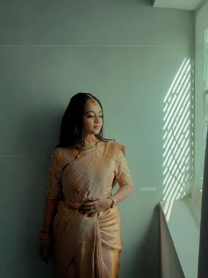 A solo portrait of the bride by the window. The play of light and shadow highlights the beautiful, subtle makeup.