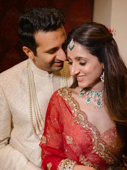 An intimate moment during their wedding celebration. The soft lighting and close framing create a romantic and personal feel.