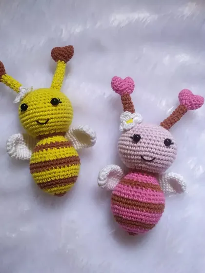 One yellow and one pink bee side-by-side. This shows how you can mix and match colors for a custom order. The little heart antennae are my favorite detail.