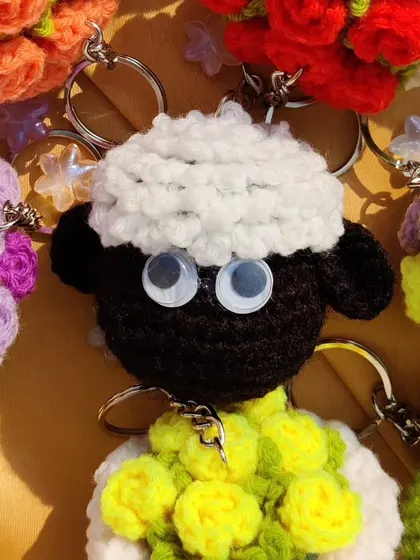 Shaun the Sheep feeling pookie, surrounded by mini bouquet keychains from a bulk order.