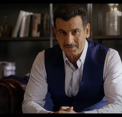 A direct-to-camera shot of Ronit Roy from the Sankalp Group ad. His confident expression and impeccable styling convey authority and trustworthiness.