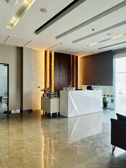 This image captures the full expanse of the lobby, showing the reflective tiled floor that enhances the sense of space and light.