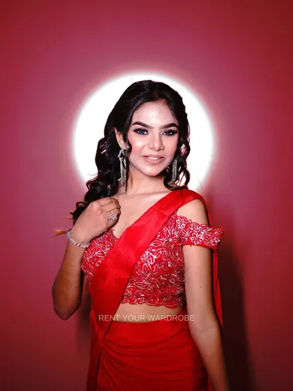 A portrait in the red ruffle saree, exuding confidence and style.