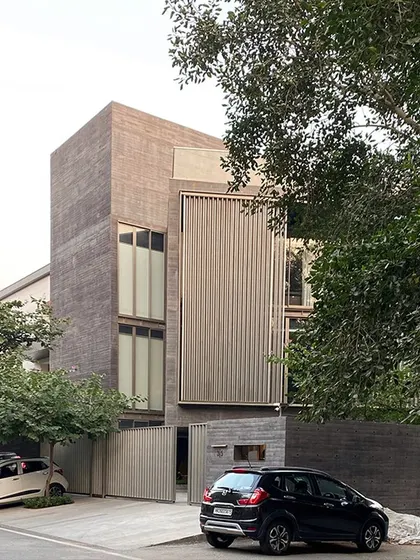 A view of The Three Mashrabiya residence, another project focused on concrete forms. Here, a large metal screen, or mashrabiya, provides privacy and filters light for the upper floors.