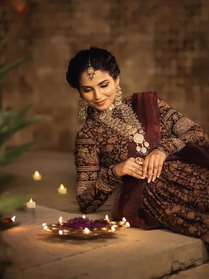 This image from our "Threads of Tradition" Deepawali shoot showcases a beautiful Kalamkari lehenga. The makeup was designed to be rich and elegant to match the outfit.