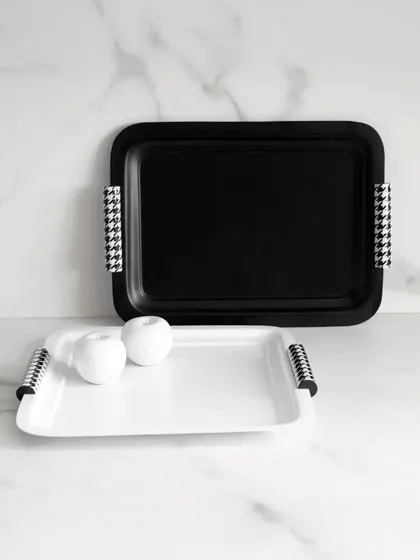 Timeless by design, these black and white trays from the Uma Black Collection feature a classic houndstooth pattern on the handles. They embody sophistication, minimalism, and quiet luxury.