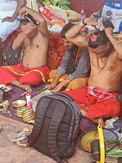 Bhoota Kola artists beginning their elaborate makeup and costume process, which can take hours.