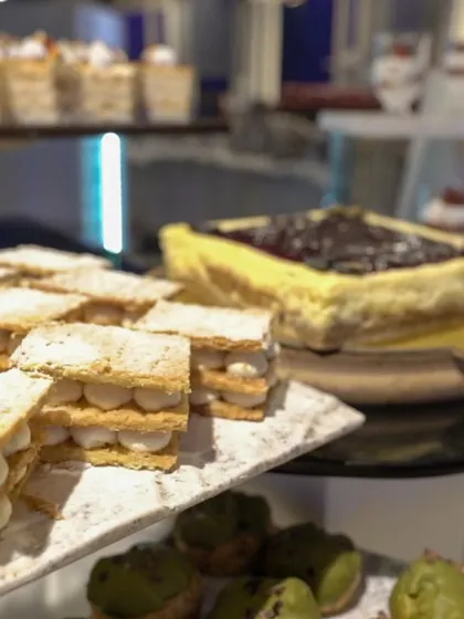 A display of our layered mille-feuille and classic cheesecake. We offer a wide range of both French-inspired patisserie and beloved classic desserts.
