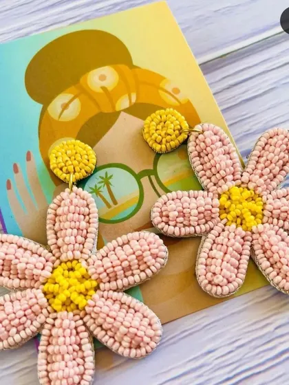 Pretty in pink! These daisy-inspired beaded earrings feature soft pink petals and a sunny yellow center, resting on our custom illustrated backing card. They are lightweight and perfect for everyday wear.