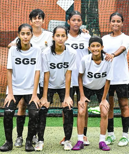 Our girls' team in their white kits, ready for action. We instill a sense of unity and purpose in all our squads.