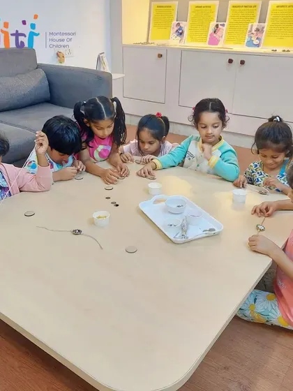 Older children work independently on their intricate Rakhi designs, showcasing the skills and concentration they have developed.