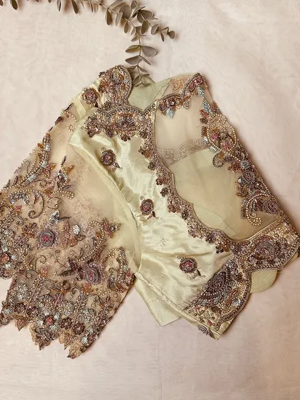 An exquisite masterpiece in pastel yellow, featuring a sheer back and sleeves with intricate floral embroidery.