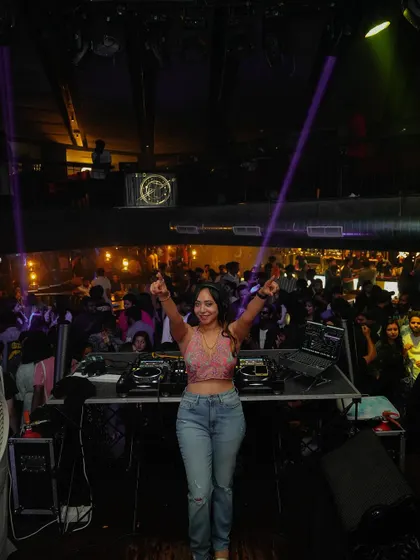 Another triumphant pose from behind the decks. I bring confidence and a positive vibe to every performance, which translates into a fun night for everyone.