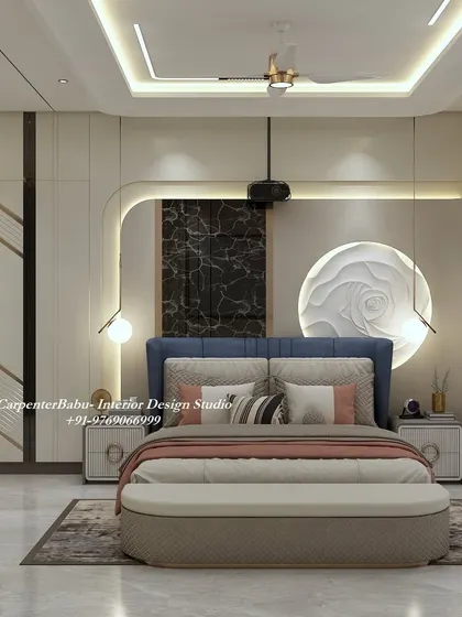 A luxurious master bedroom with a deep blue headboard and abstract wall art. The design uses a mix of textures, from the 3D rose sculpture to the dark marble panel, to create a rich and sophisticated space.